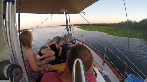 relaxing on the bow of sailboat anchored out