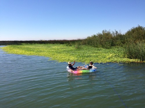 Two people floating on an inflatable raft